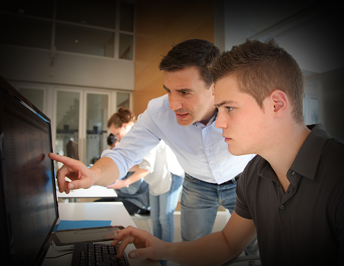 An Instructor points out a faster solution to a student on a computer screen