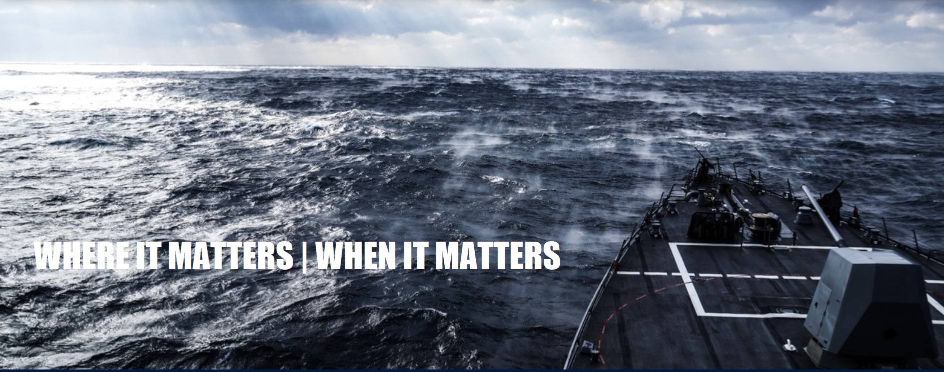 Dark rough ocean waves viewed from the back of an aircraft carrier