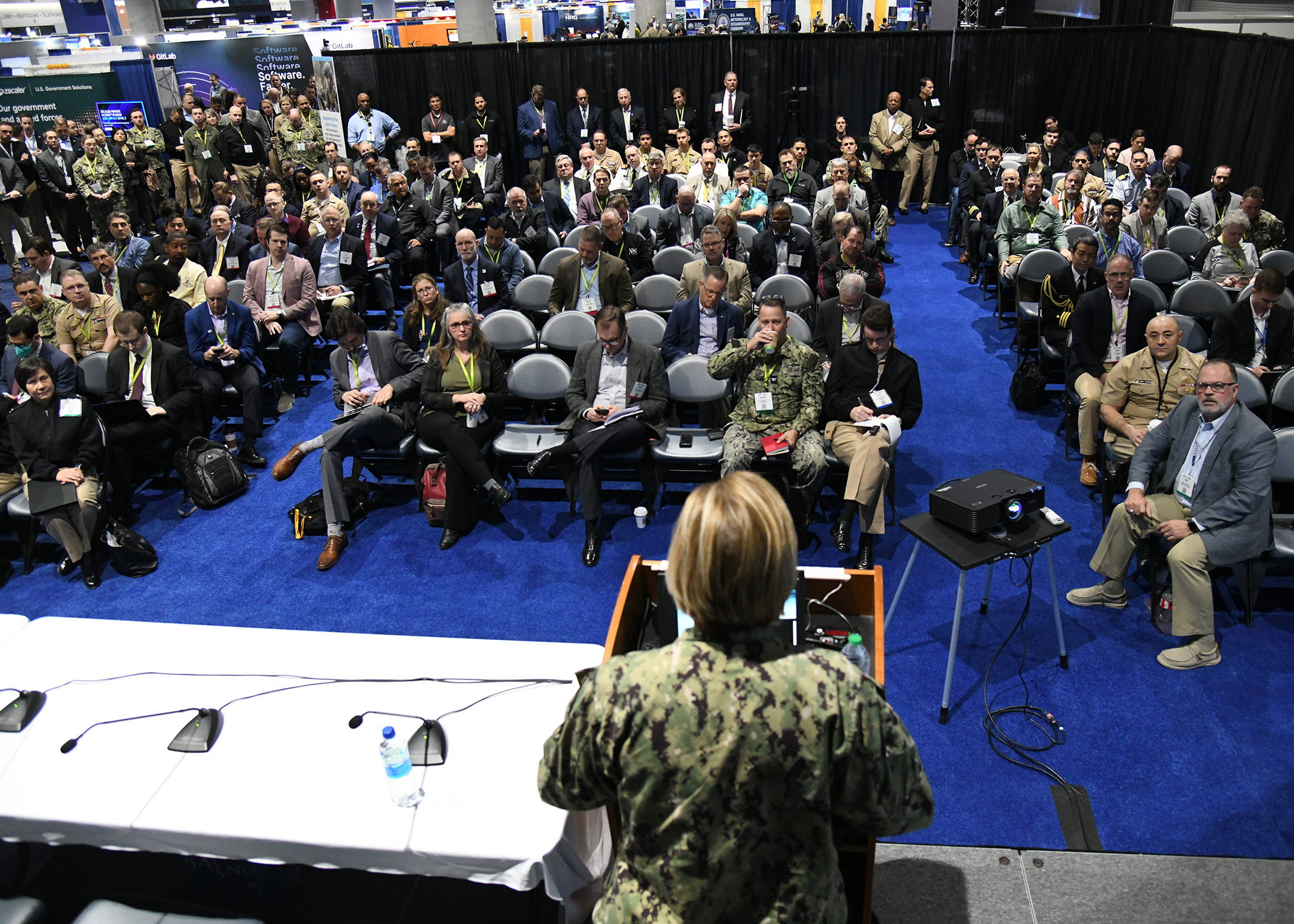A U.S. female soldier faces a diversified audience giving a presentation