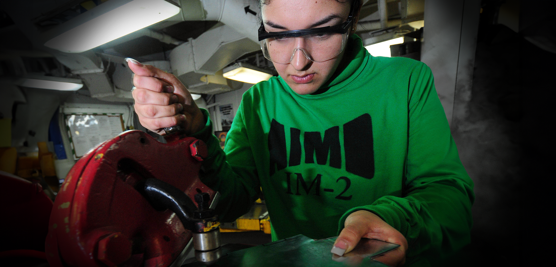 A New Professional works in her first position crafting a prototype steel hinge