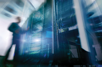 Image of blurry man in front of server racks